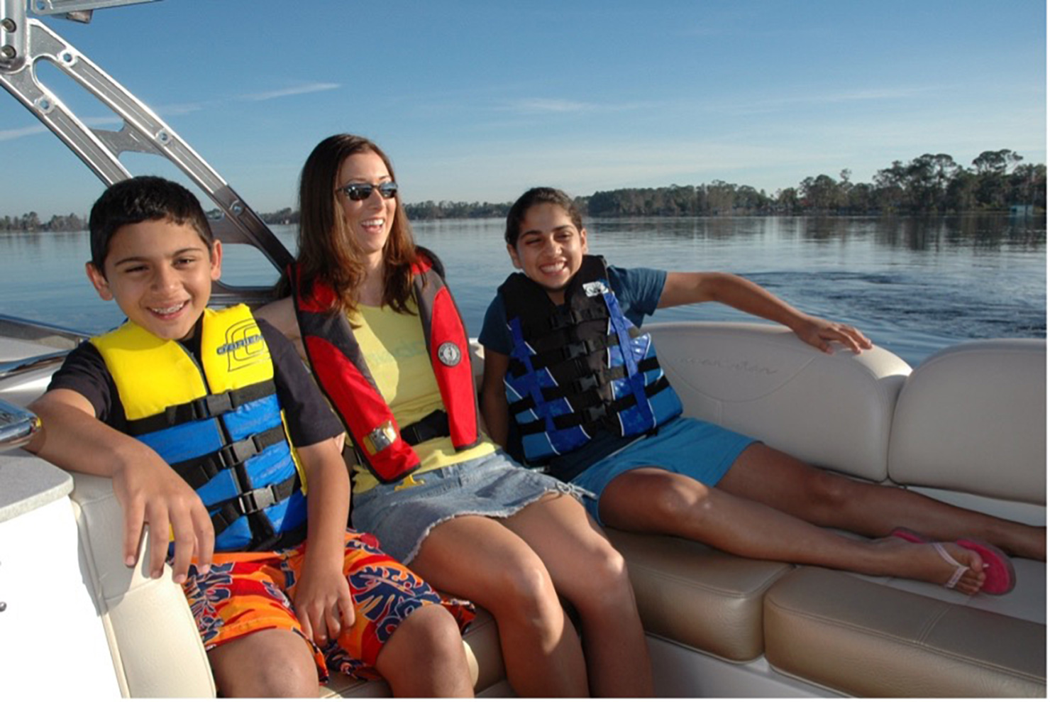 family on a boat wearing life jackets