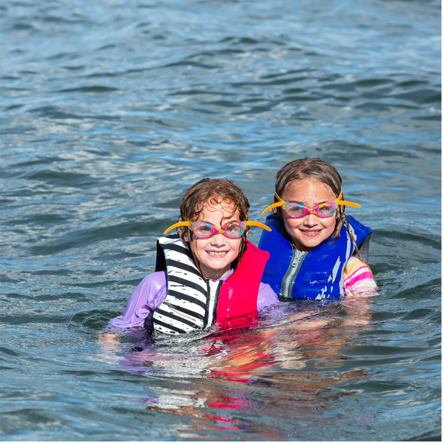 kids wearing life jackets in the water