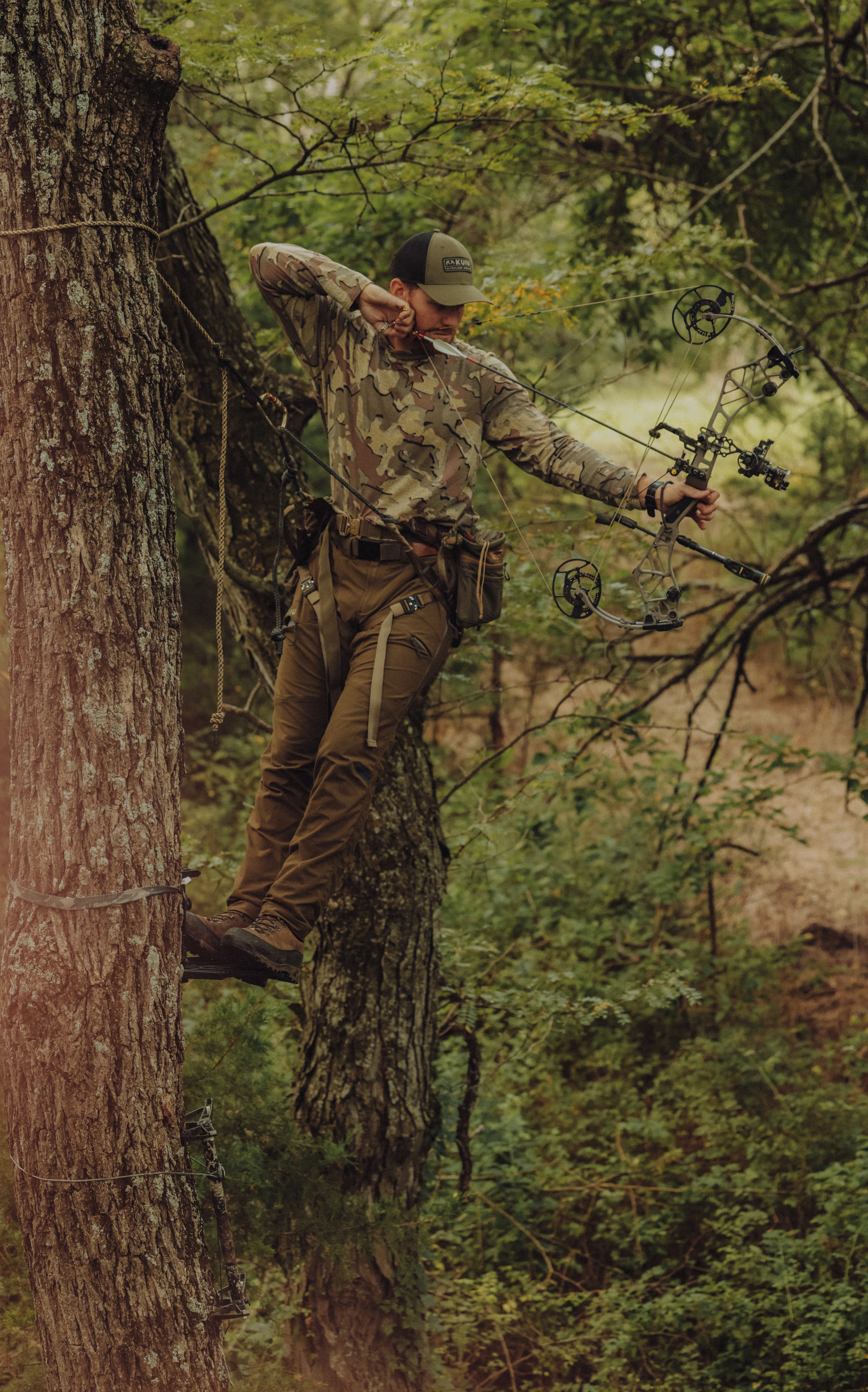 Bowhunter tethered to a tree and shooting to the right